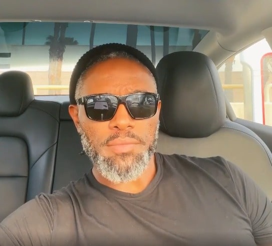 Darius McCrary posing for a photo shoot in his car.